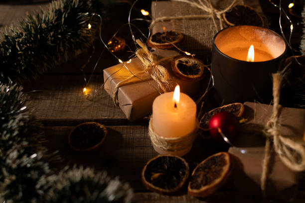 istock Christmas gifts and ornaments illuminated by candlelight. 2175659846