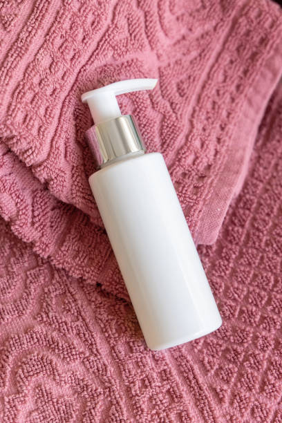 istock White blank pump bottle on pink folded bath towels close up, cosmetic mockup 2175659881