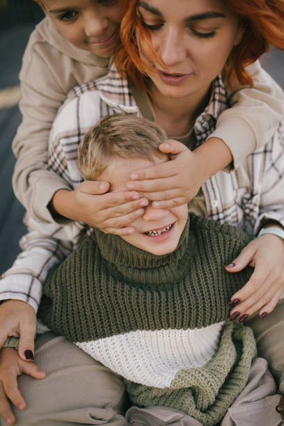 istock Happy mother and her two sons having fun spending time together outdoors. 2175659968