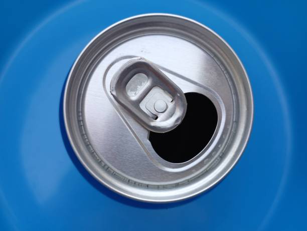 istock An open metal can with a drink on a blue background. Top view of an empty beverage can. 2175660444