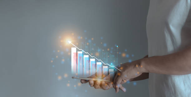 istock Young man hand using smartphone to visualize money growth The phone screen displays graphs and charts showing increasing investment and savings trends, along with an increased account balance 2175660923