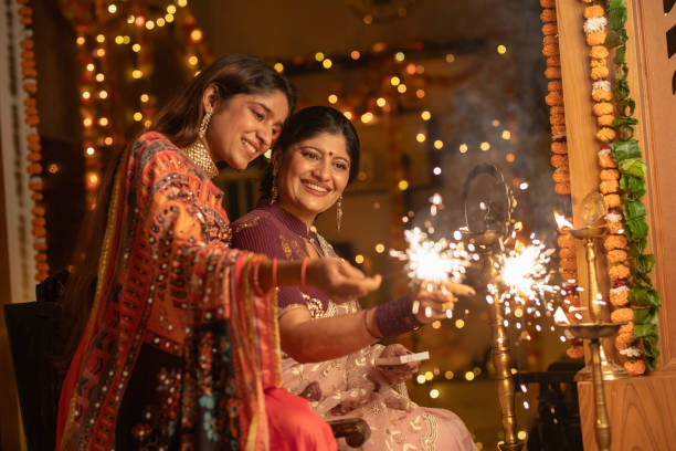 istock Female burning sparklers at home during Diwali celebration 2175661325