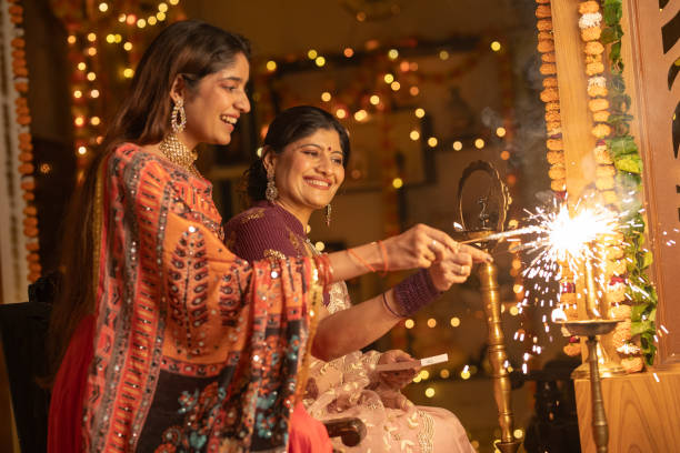istock Female burning sparklers at home during Diwali celebration 2175661406