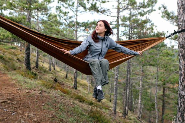 istock Woman sitting in a hammock 2175663051