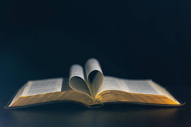 Bible and hearts isolated on white