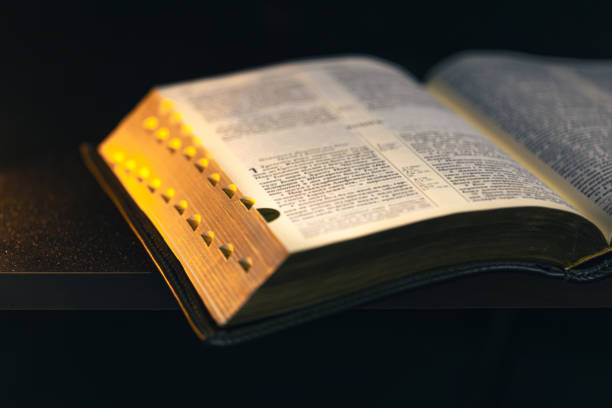 istock Open Bible on a black background. Religion concept. 2175663283
