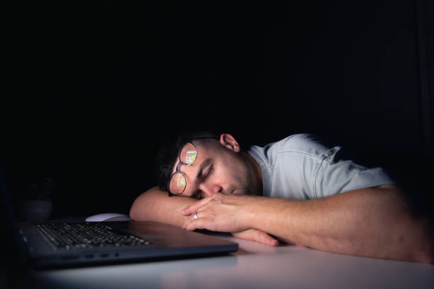 istock Young man works at the computer at night. 2175664126