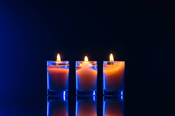 Burning candle on black background with backlight. . Memorial Day. High quality photo