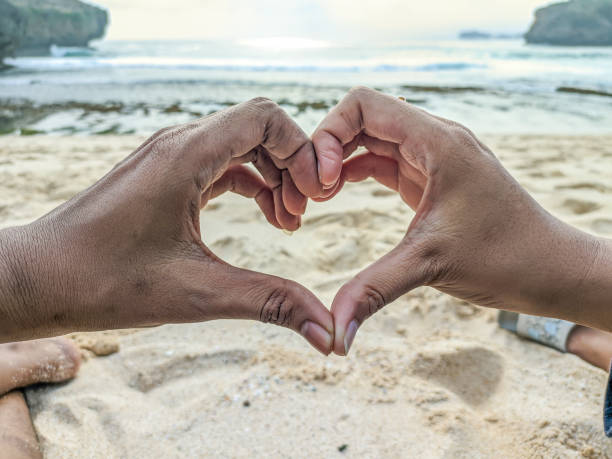 istock Couple's hands form a heart symbol of affection 2175665386