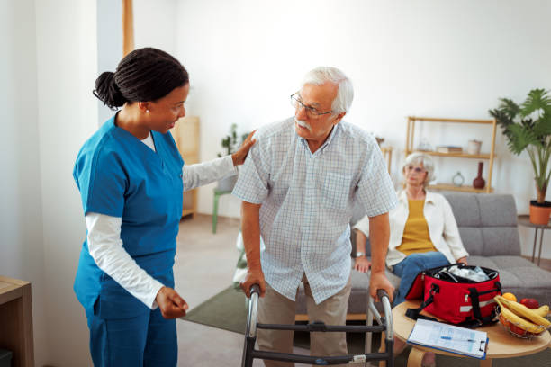 istock Female nurse helping senior man with mobility walker at home 2175665874
