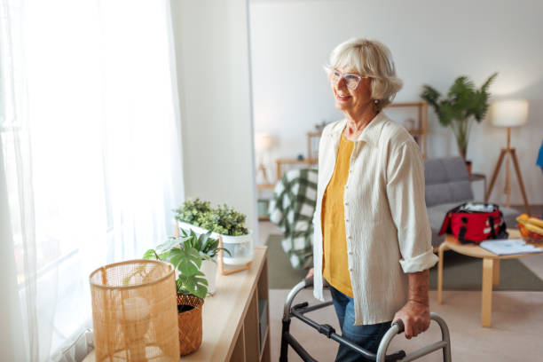 istock Senior woman with mobility walker enjoying a view from her window at home 2175665931