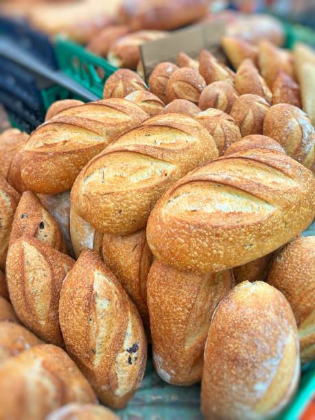 Food commerce and everyday shopping. Sale of bread with a close-up view of bakery products on shelves in a store or bakery.