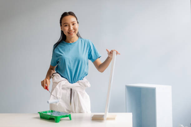 istock Woman painting in a bright, modern room with roller 2175668950