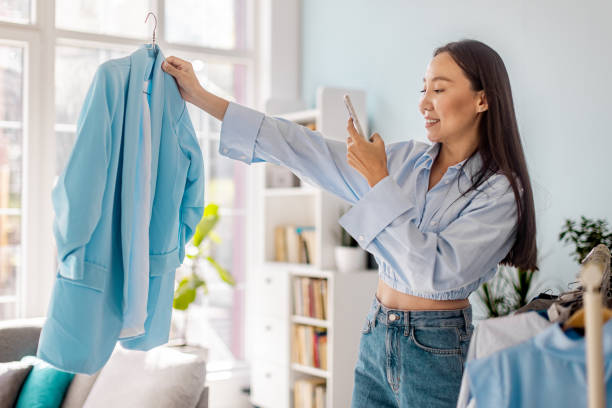 istock Woman photographing blue blazer in bright room setup. 2175669201