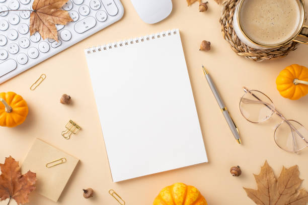 istock Flat lay of an autumn-themed workspace featuring a blank notebook, coffee mug, mini pumpkins, and keyboard 2175669863
