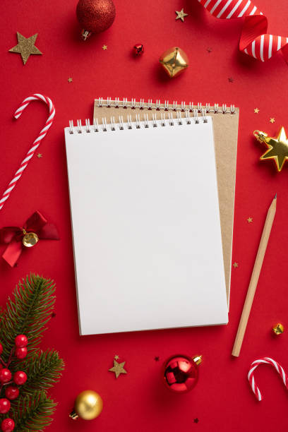 istock Festive Christmas vertical setting with baubles, candy canes, and blank notepad on red background, perfect for holiday planning or messages 2175669883