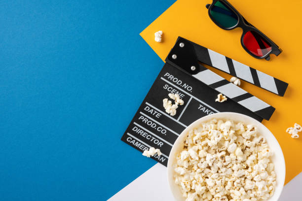 istock A high-angle view of popcorn, a clapperboard, and 3D glasses on a colorful background, symbolizing the excitement of watching films 2175669949