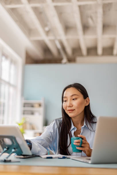 istock Woman working with tablet and cup in bright room 2175672417