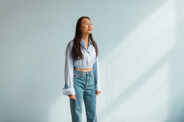 istock Young woman enjoys peaceful moment in natural light 2175673112