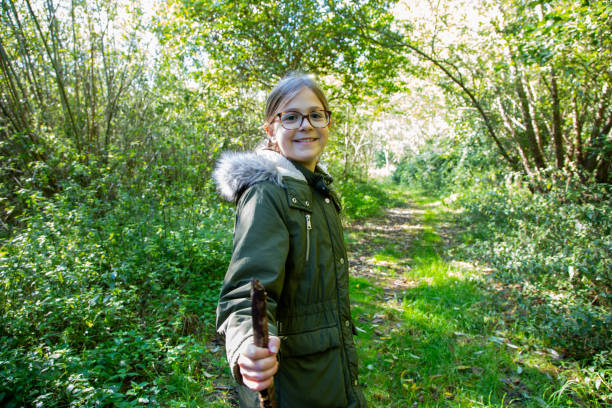 Girl enjoying a woodland walk surrounded by greenery