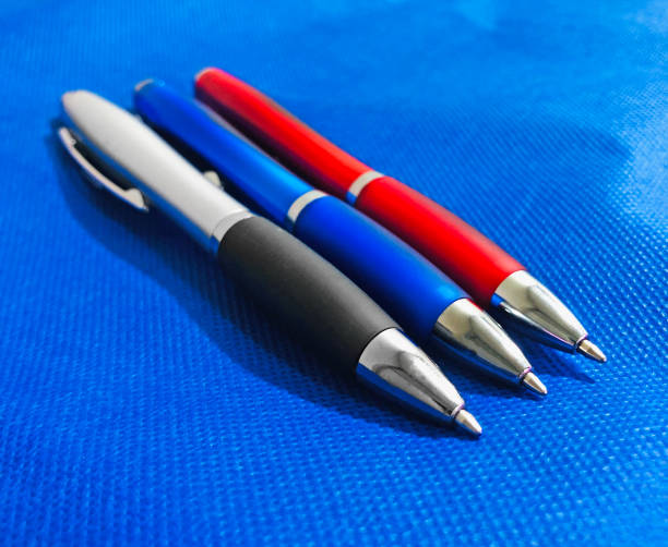 istock Three pens, red, blue and the last gray. All three are in a horizontal position. 2175676377