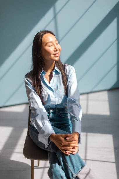 istock Peaceful woman basking in sunlight with closed eyes 2175677051