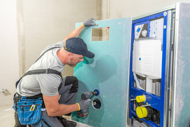 istock In-wall toilet system assembly. Worker does sheathing the  build-in cistern with plasterboard. 2175678763