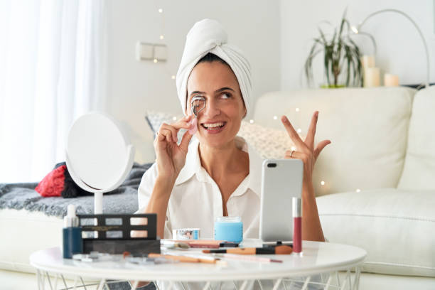 istock Happy woman applying eyelash curler 2175679696