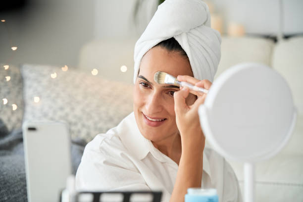 istock Delighted woman applying foundation with brush 2175679762