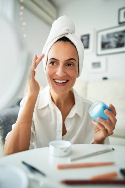 istock Happy woman applying face cream 2175679971