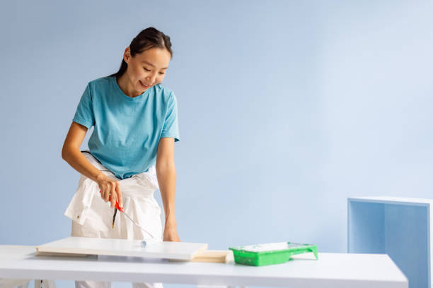 istock Smiling person painting with tray and roller tool 2175680167