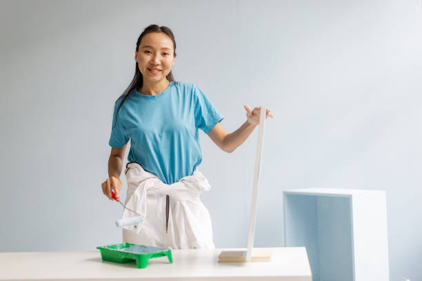 istock Smiling woman with paint roller preparing to decorate 2175681484