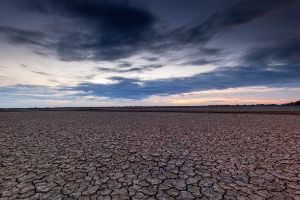 istock Arid landscape,Dry barren land with cloudy polluted sky, climate change and desertification concept 2175681523