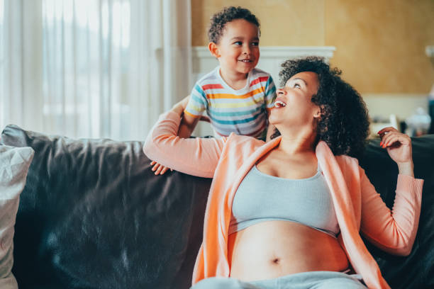 istock Pregnant woman at home having fun with her son 2175682092