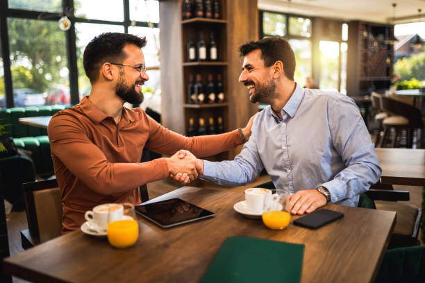istock Two colleagues hanging out at the coffee shop. Working together on tablet. 2175684729