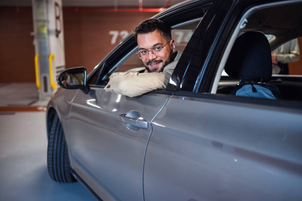 istock Businessman parking in reverse in an underground garage. 2175686405