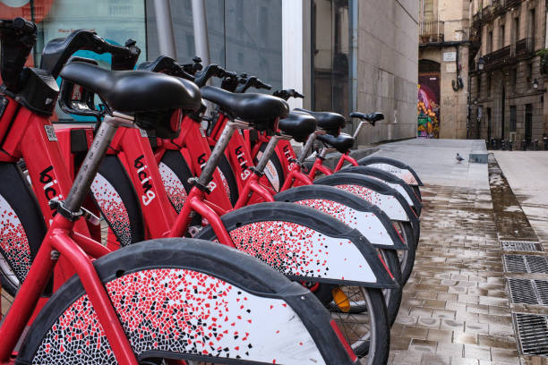Bicycles for urban mobility in Barcelona lined up in their parking in one of the streets of the old town of Barcelona.