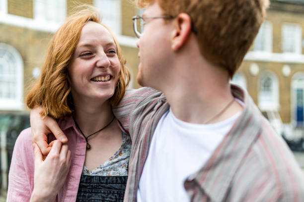 istock Young couple holding hands and looking at each other 2175689894