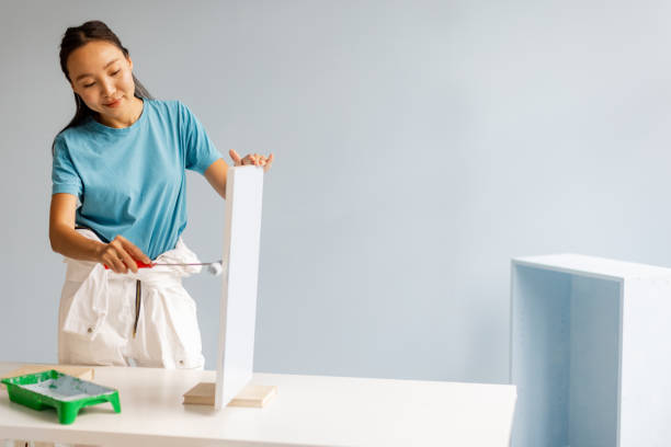 istock Creative journey: woman paints in stylish modern room 2175690364