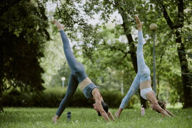 istock Mom and Daughter Standing in Yoga Pose 2175690432
