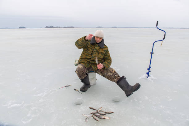 istock Man fishing in winter 2175691458