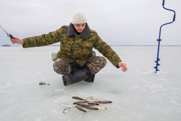 istock Man fishing in winter 2175691466