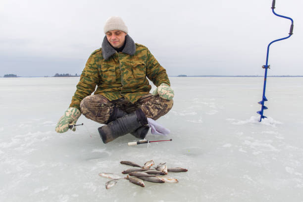 istock Man fishing in winter 2175691492