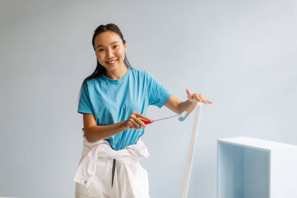 istock Female artist paints with focus in spacious studio. 2175691522