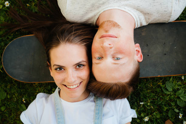 istock Two friends bonding on the grass 2175692250