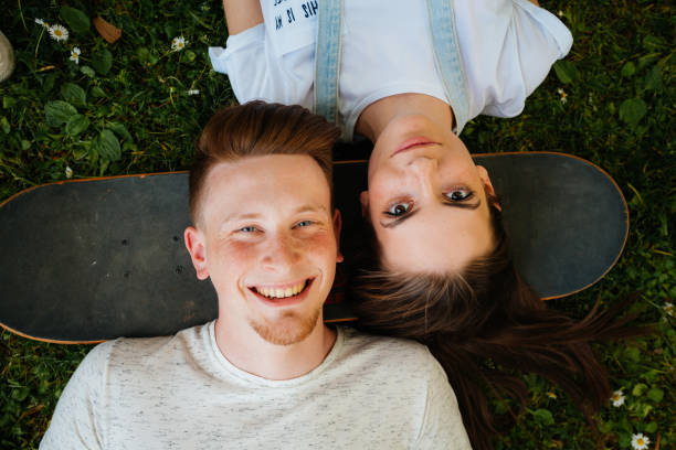 istock Two friends bonding on the grass 2175692311
