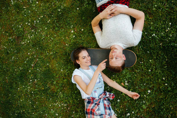 istock Two friends bonding on the grass 2175692360