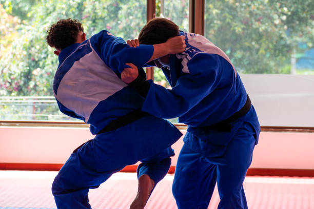 istock Judo fighters fighting in dojo 2175701236