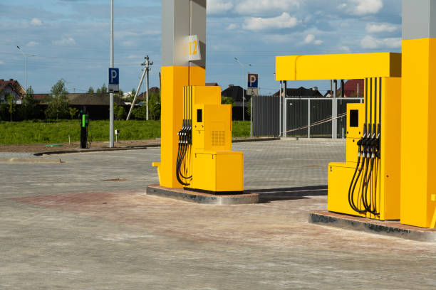 istock A bright, modern fuel station features yellow pumps set in a spacious, open area under a clear blue sky. Nearby parking spaces are visible, enhancing accessibility 2175704058