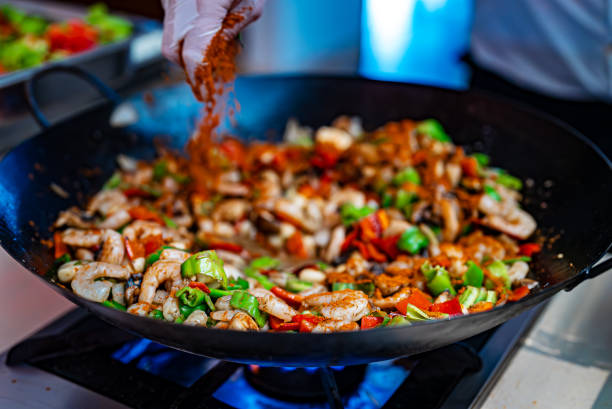 istock The chef cooks shrimps with vegetables in a wok. 2175704762